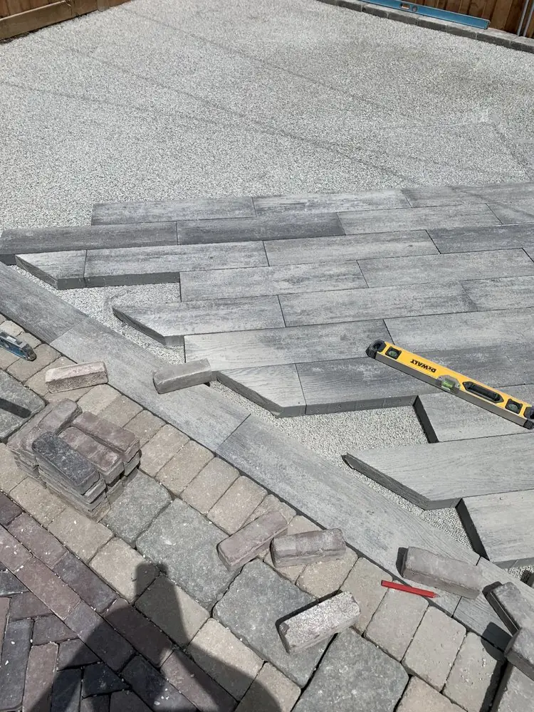 Long plank paver installation with level and sand base