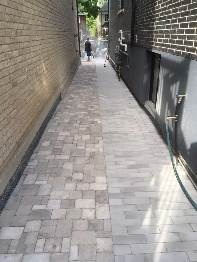 Stone paver side walkway between houses